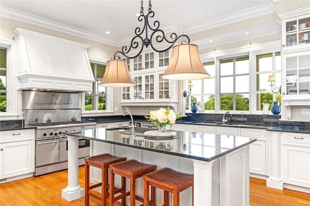 15 Courageous Cir, Bristol, RI 02809 - kitchen with range with two ovens, light wood-style floors, white cabinetry, crown molding, and recessed lighting