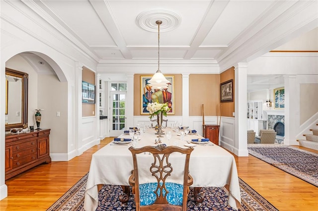 15 Courageous Cir, Bristol, RI 02809 - dining room with light wood-style floors, coffered ceiling, a decorative wall, arched walkways, and beamed ceiling