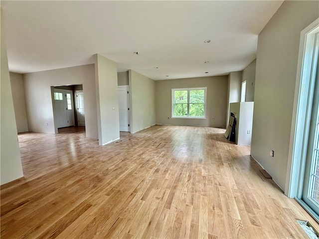 94 Ashaway Rd, Westerly, RI 02891 - unfurnished living room with light wood-style floors and a fireplace with flush hearth