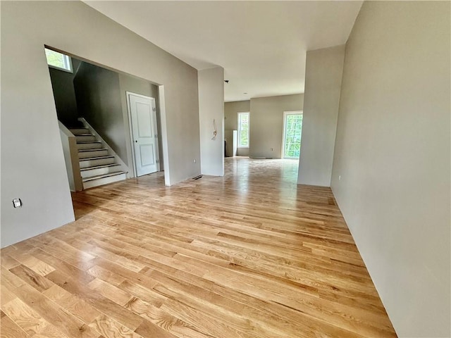94 Ashaway Rd, Westerly, RI 02891 - unfurnished living room with light wood-type flooring and stairs