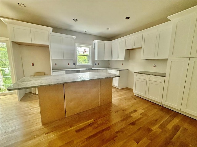 94 Ashaway Rd, Westerly, RI 02891 - kitchen featuring a center island, light wood finished floors, white cabinetry, light stone counters, and recessed lighting