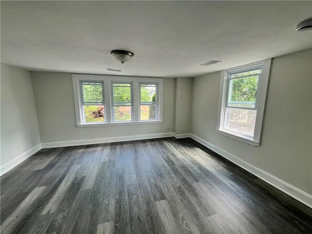 22 Agnes St, West Warwick, RI 02893 - empty room featuring dark wood-style floors and healthy amount of natural light