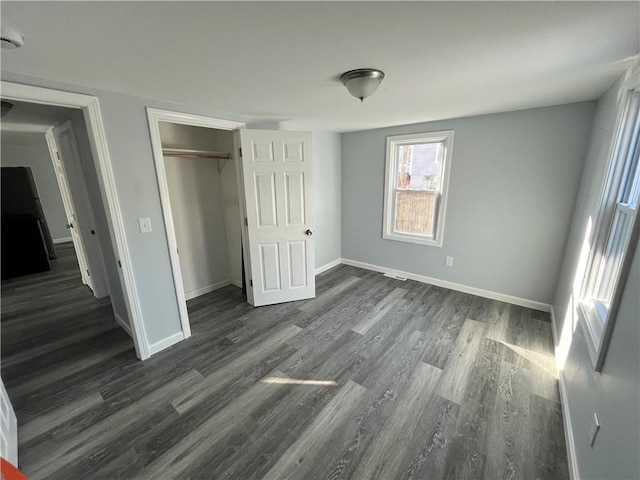 22 Agnes St, West Warwick, RI 02893 - unfurnished bedroom with dark wood-type flooring and a closet