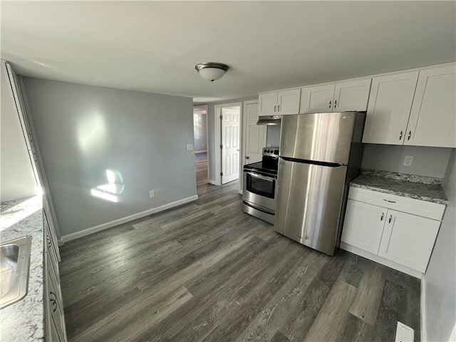22 Agnes St, West Warwick, RI 02893 - kitchen with appliances with stainless steel finishes, dark wood finished floors, under cabinet range hood, white cabinets, and light stone counters