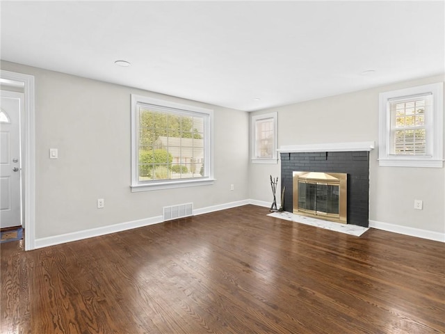 10 Palmer St, Smithfield, RI 02828 - unfurnished living room featuring plenty of natural light, wood finished floors, and a brick fireplace