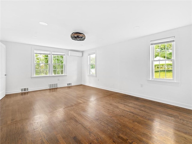 10 Palmer St, Smithfield, RI 02828 - spare room with an AC wall unit, plenty of natural light, and wood finished floors
