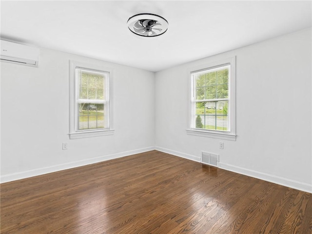 10 Palmer St, Smithfield, RI 02828 - unfurnished room with a wall unit AC and dark wood-type flooring