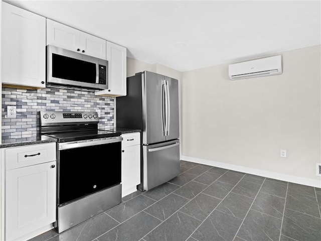 10 Palmer St, Smithfield, RI 02828 - kitchen with stainless steel appliances, a wall mounted AC, white cabinets, backsplash, and dark stone countertops