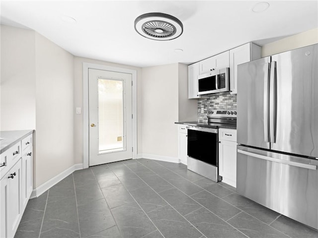 10 Palmer St, Smithfield, RI 02828 - kitchen with appliances with stainless steel finishes, tasteful backsplash, and white cabinetry