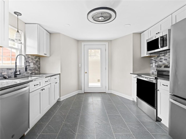 10 Palmer St, Smithfield, RI 02828 - kitchen featuring stainless steel appliances, decorative backsplash, white cabinets, and light stone counters