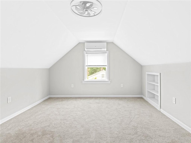 10 Palmer St, Smithfield, RI 02828 - bonus room featuring carpet, built in shelves, a wall unit AC, and vaulted ceiling