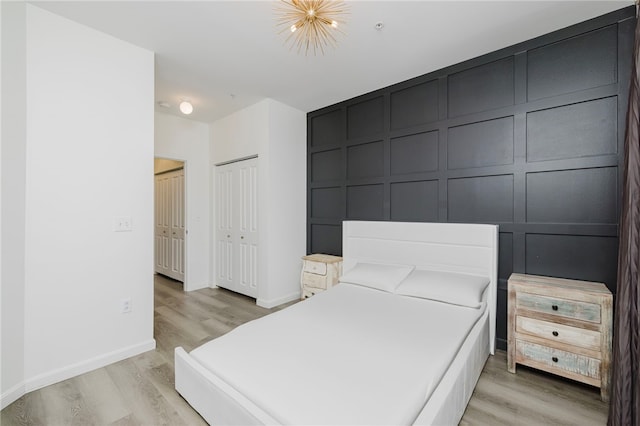 1000 Providence Pl Unit 467, Providence, RI 02903 - bedroom featuring wood finished floors and a decorative wall