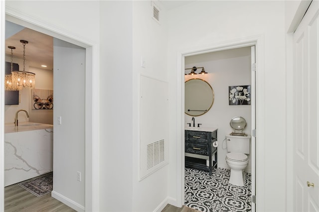 1000 Providence Pl Unit 467, Providence, RI 02903 - bathroom featuring a chandelier, vanity, and wood finished floors