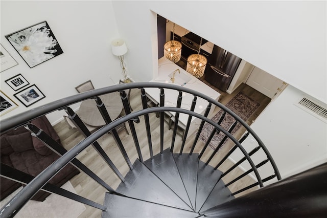 1000 Providence Pl Unit 467, Providence, RI 02903 - stairway featuring wood finished floors and a chandelier