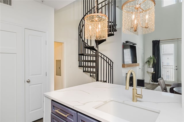1000 Providence Pl Unit 467, Providence, RI 02903 - kitchen with a chandelier, healthy amount of natural light, light stone countertops, and a towering ceiling