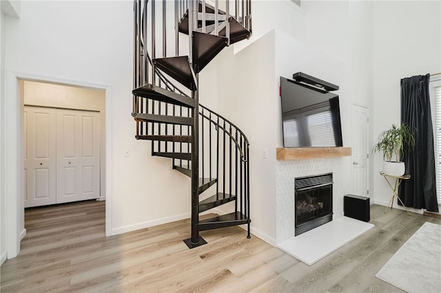 1000 Providence Pl Unit 467, Providence, RI 02903 - staircase featuring a high ceiling, wood finished floors, and a fireplace