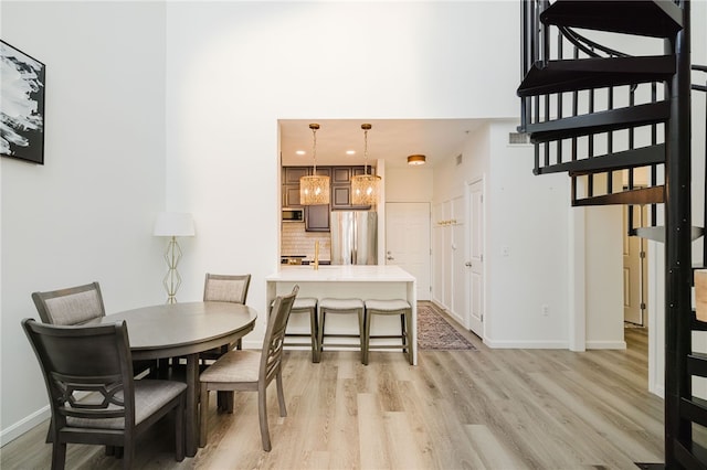 1000 Providence Pl Unit 467, Providence, RI 02903 - dining area featuring light wood-type flooring, a high ceiling, and recessed lighting