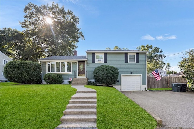 62 Pembroke Ln, Coventry, RI 02816 - tri-level home with asphalt driveway and a garage