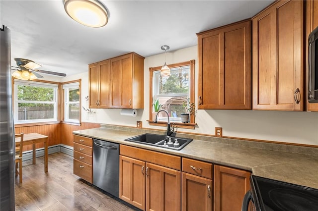 62 Pembroke Ln, Coventry, RI 02816 - kitchen featuring stainless steel dishwasher, healthy amount of natural light, a baseboard radiator, and wood finished floors