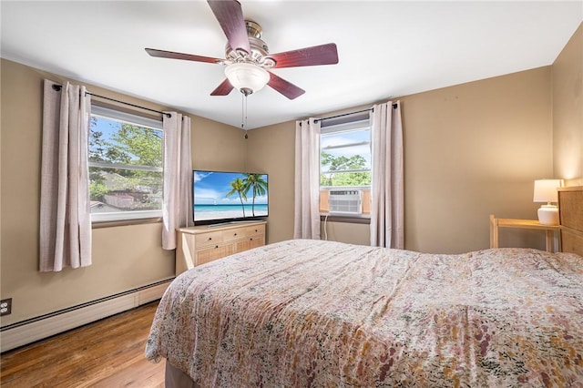 62 Pembroke Ln, Coventry, RI 02816 - bedroom with baseboard heating, cooling unit, multiple windows, and wood finished floors