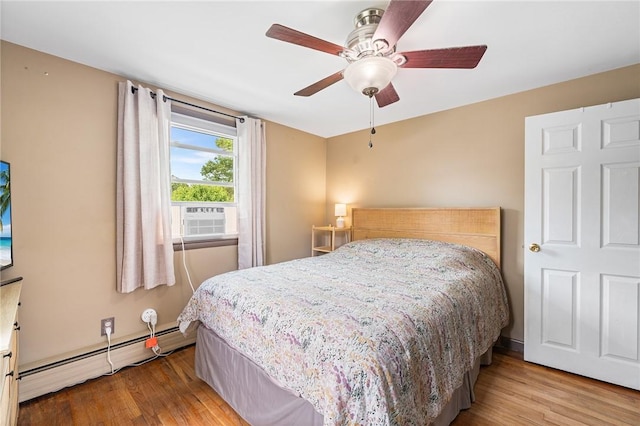 62 Pembroke Ln, Coventry, RI 02816 - bedroom with wood finished floors, a baseboard heating unit, ceiling fan, and cooling unit