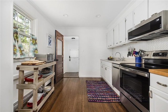 7 Pleasant Vw, Jamestown, RI 02835 - kitchen with stainless steel appliances, dark wood-style floors, white cabinetry, backsplash, and ornamental molding