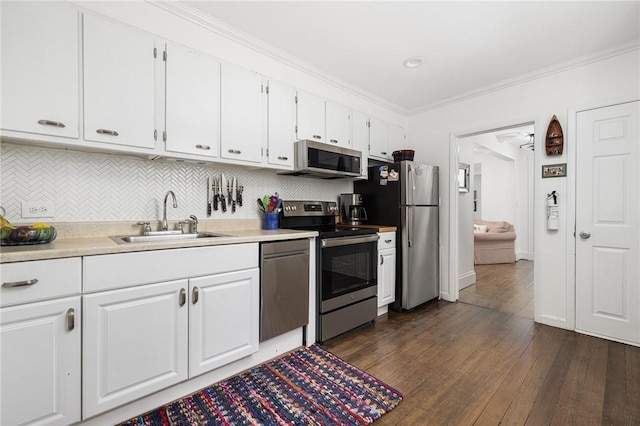 7 Pleasant Vw, Jamestown, RI 02835 - kitchen with appliances with stainless steel finishes, white cabinets, dark wood-style floors, decorative backsplash, and light countertops