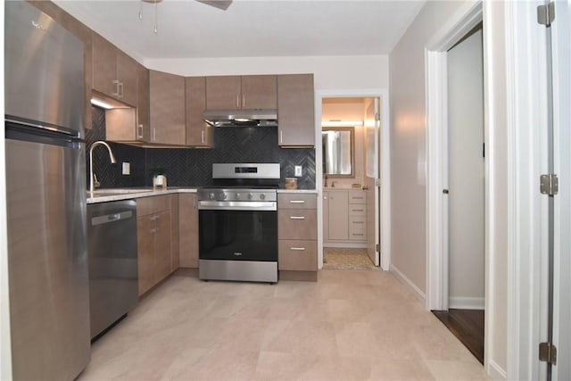 132 Hoffman Ave Unit 202, Cranston, RI 02920 - kitchen featuring stainless steel appliances, under cabinet range hood, backsplash, and light countertops