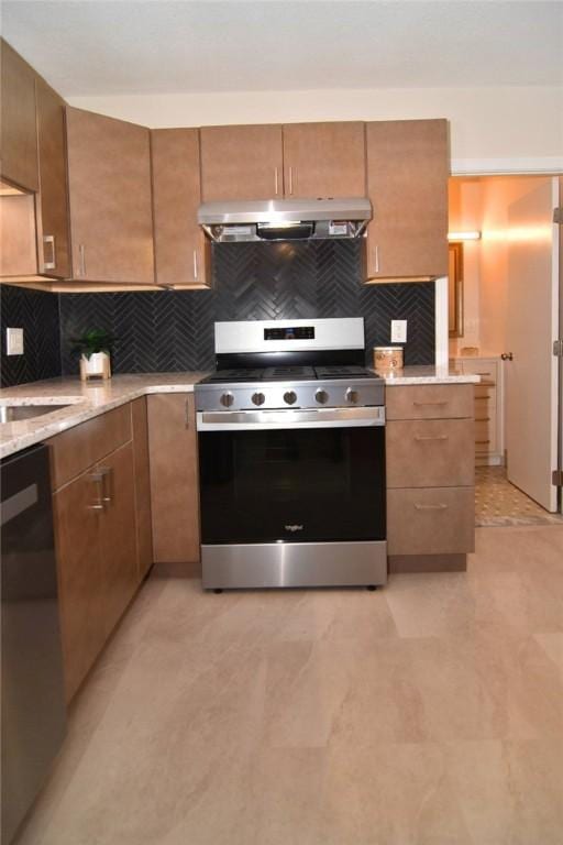 132 Hoffman Ave Unit 202, Cranston, RI 02920 - kitchen featuring stainless steel range with gas stovetop, under cabinet range hood, dishwasher, tasteful backsplash, and brown cabinetry