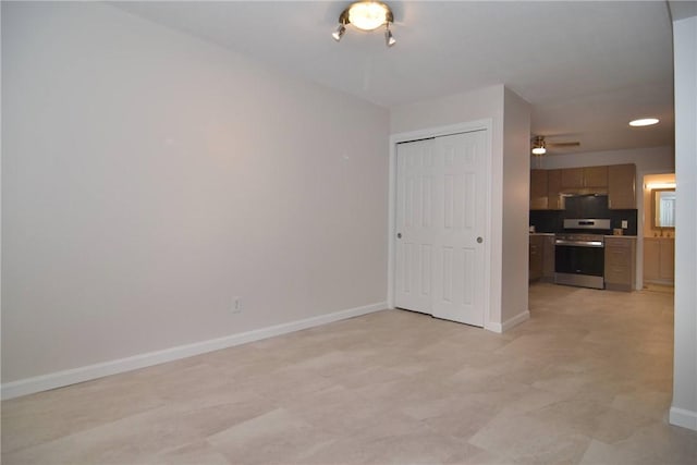 132 Hoffman Ave Unit 202, Cranston, RI 02920 - unfurnished living room featuring baseboards and a ceiling fan