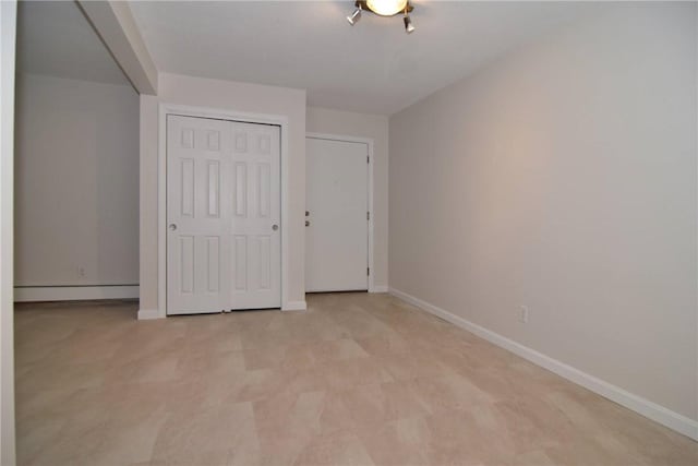 132 Hoffman Ave Unit 202, Cranston, RI 02920 - unfurnished bedroom with a baseboard heating unit, a closet, and light colored carpet