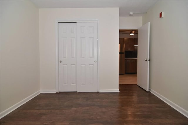 132 Hoffman Ave Unit 202, Cranston, RI 02920 - unfurnished bedroom with freestanding refrigerator, dark wood-style floors, and a closet