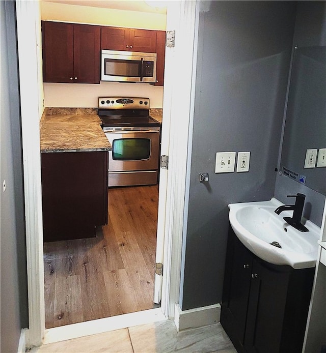 84 Tell St Unit 4A, Providence, RI 02909 - kitchen with appliances with stainless steel finishes and light wood-type flooring