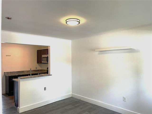 84 Tell St Unit 4A, Providence, RI 02909 - unfurnished dining area with dark wood-style flooring and baseboards