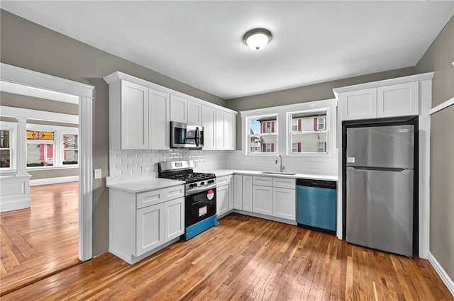 15 Melissa St, Providence, RI 02909 - kitchen with appliances with stainless steel finishes, healthy amount of natural light, light countertops, and backsplash