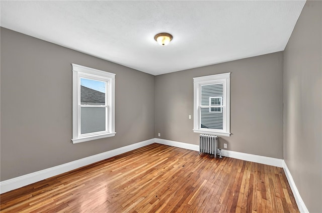 15 Melissa St, Providence, RI 02909 - spare room featuring radiator heating unit and wood-type flooring