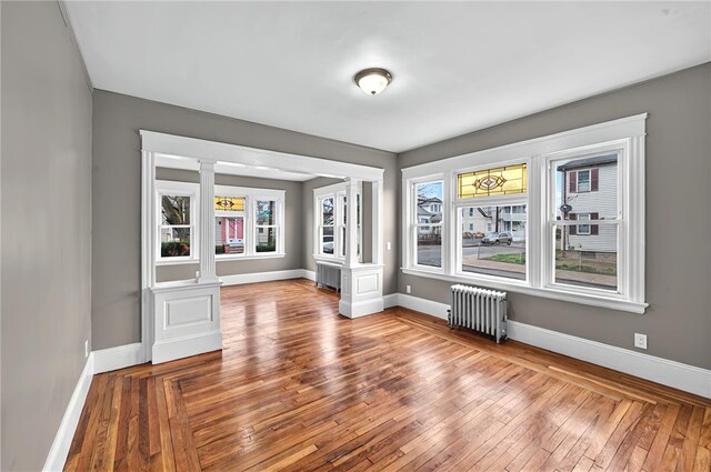 15 Melissa St, Providence, RI 02909 - empty room with radiator, ornate columns, and healthy amount of natural light