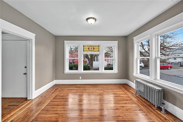 15 Melissa St, Providence, RI 02909 - unfurnished dining area featuring radiator, light wood-type flooring, and healthy amount of natural light