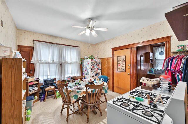 15 Melissa St, Providence, RI 02909 - dining area with wallpapered walls, light carpet, a ceiling fan, and wainscoting