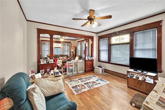 15 Melissa St, Providence, RI 02909 - living room featuring a ceiling fan, crown molding, wood finished floors, healthy amount of natural light, and a baseboard radiator
