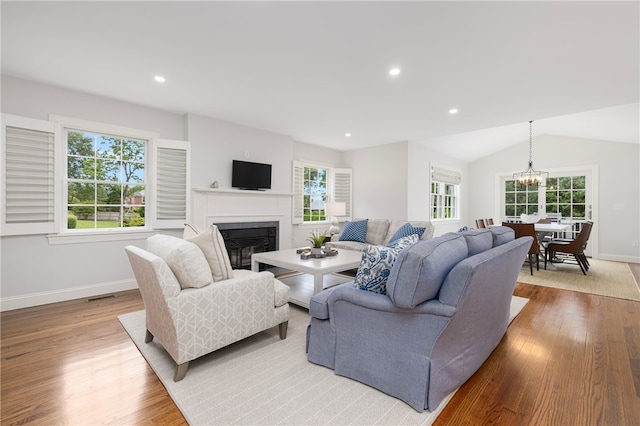 10 Linden Gate Ln, Newport, RI 02840 - living room with wood finished floors, a glass covered fireplace, a chandelier, recessed lighting, and vaulted ceiling