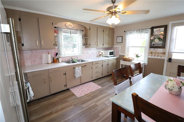 10 Park Way, Lincoln, RI 02838 - kitchen with white microwave, light wood-style floors, backsplash, light countertops, and a ceiling fan