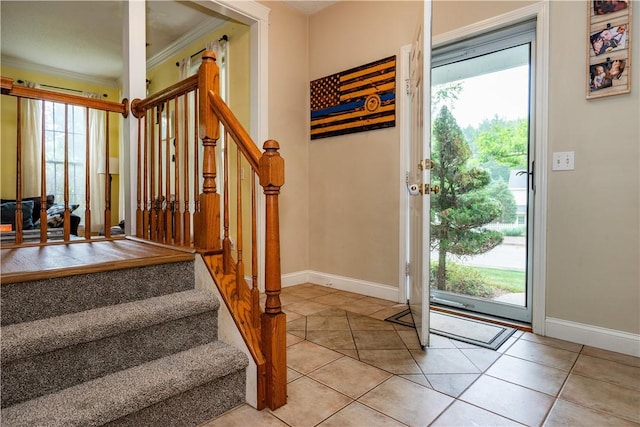 50 S Pond Dr, Coventry, RI 02816 - foyer with crown molding, healthy amount of natural light, light tile patterned flooring, and stairway