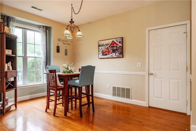 50 S Pond Dr, Coventry, RI 02816 - dining space featuring wood finished floors, plenty of natural light, and a chandelier