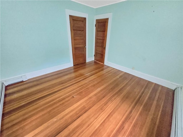 156 Broad St, Burrillville, RI 02859 - spare room with light wood finished floors, crown molding, and a baseboard radiator
