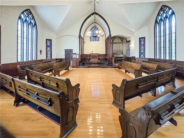156 Broad St, Burrillville, RI 02859 - living area featuring a chandelier, wood finished floors, arched walkways, vaulted ceiling, and wainscoting
