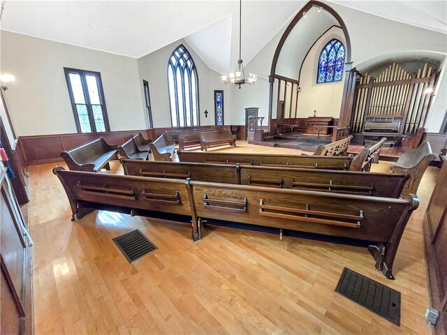 156 Broad St, Burrillville, RI 02859 - living area with wood finished floors, a chandelier, lofted ceiling, and wainscoting