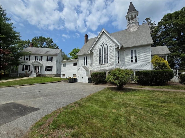 156 Broad St, Burrillville, RI 02859 - view of front of property featuring driveway, a garage, a chimney, and a front yard