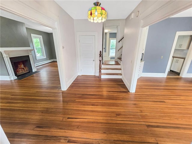 156 Broad St, Burrillville, RI 02859 - foyer with hardwood / wood-style floors, healthy amount of natural light, stairway, and a fireplace with flush hearth