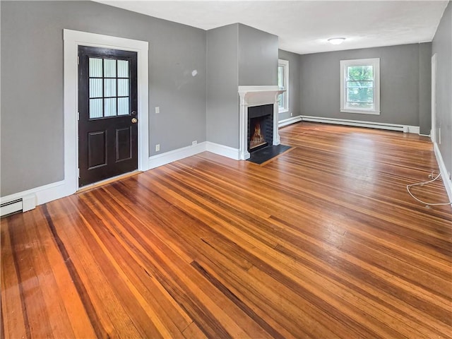 156 Broad St, Burrillville, RI 02859 - unfurnished living room with a baseboard radiator, wood finished floors, and a fireplace with flush hearth